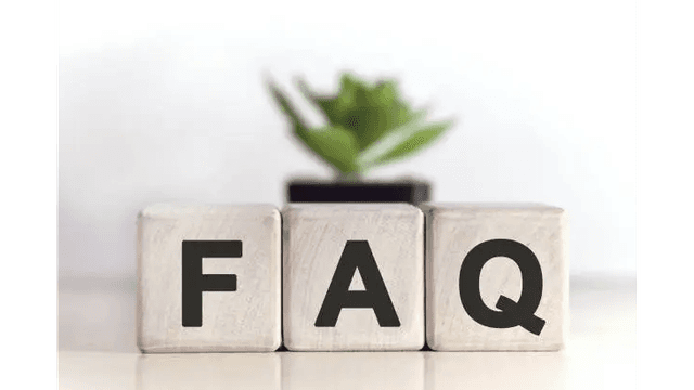 Wooden blocks spelling "FAQ" with a small plant behind them.